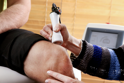 Doctor treating a patient with a Laser physiotherapy